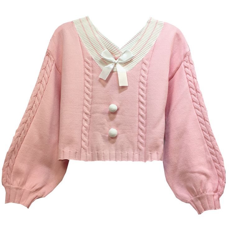 a pink cropped sweater with a vneck, white trim, and a white bow at the neck. the sweater has cable knit detailing, two white buttons, and long, oversized sleeves.