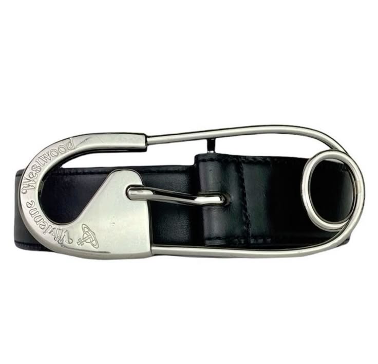 a black leather belt with a silver safety pin buckle. the buckle is engraved with the vivienne westwood orb logo. the belt is a fashion accessory and is likely a designer belt.