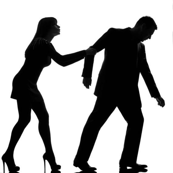 a silhouette of a man and woman walking away from each other. the woman is holding the man's hand and appears to be trying to stop him from leaving. the man is looking down and appears to be sad.
