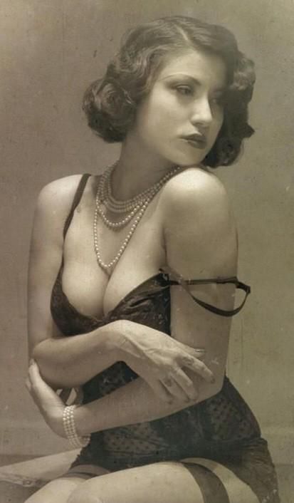 a vintagestyle portrait of a woman in lingerie, wearing a pearl necklace and bracelet. the image has an old photo effect, suggesting a retro aesthetic. the woman is looking away with a subtle, seductive expression.