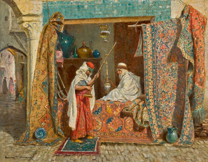 this is an orientalist painting depicting a scene in a middle eastern or north african setting, possibly a bazaar or marketplace. a guard is standing in the foreground holding a rifle. he is wearing a fez and a red robe with a white turban. seated behind him is a man in a white robe and turban. they are positioned within a decorated space defined by carpets draped on ropes and architectural elements like arches and pillars. pottery and other decorative items are visible on a shelf behind them. the courtyard or street in the background shows other figures passing by. the overall impression is of a vibrant and exotic scene. the painting is likely by rudolph ernst, given the style and subject matter.