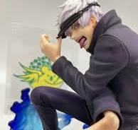 the image shows a closeup of an animestyle figurine. the figure is crouched, wearing a darkcolored, possibly purple, jacket and what appears to be a blindfold.  the character has short, gray hair, and their expression is intense and slightly mischievous. the figurine appears to be of high quality, with detail in the clothing and facial features. the background includes a painted backdrop that seems to show part of a stylized scene or logo, adding to the collectible nature of the piece.  the overall style is dynamic and actionoriented.