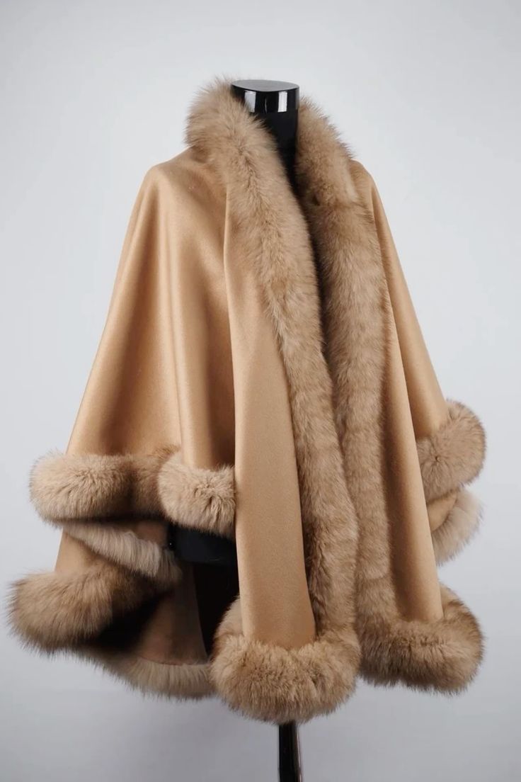 a brown fur coat with a fur collar and lining. it is a stylish and elegant piece of clothing that would be perfect for a winter day. it is warm, soft, and cozy. the coat is on a mannequin in a white background.