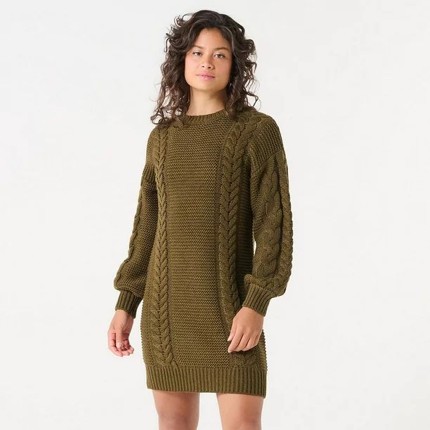 a woman is standing against a white background, showcasing a stylish olive green cable knit sweater dress. the dress features long, slightly oversized sleeves and a comfortable, relaxed fit.  the model's pose and the clean backdrop highlight the garment's texture and design. the overall style suggests a casual, autumnal or winter look.