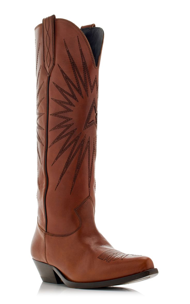 a pair of women's brown leather cowboy boots are shown in this image. the boots are tall, reaching midcalf, and feature a pointed toe. they are adorned with an embroidered starburst design. the boots are made of highquality leather and have a subtle heel. the boots are presented on a white background, highlighting the detail and craftsmanship.