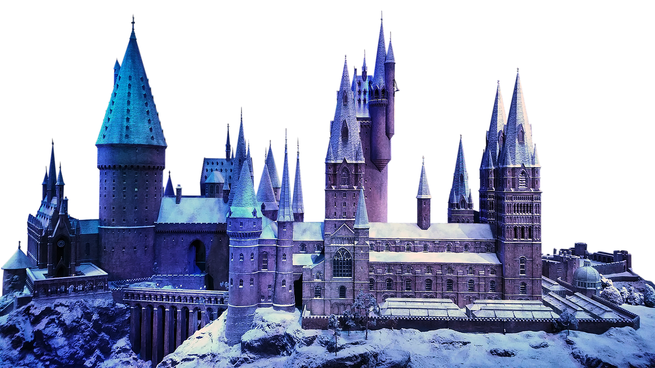 a detailed model of hogwarts castle covered in snow, illuminated against a black background. the castle features numerous towers, spires, and turrets, showcasing its architectural details. the scene evokes a wintery, magical, and fictional setting.