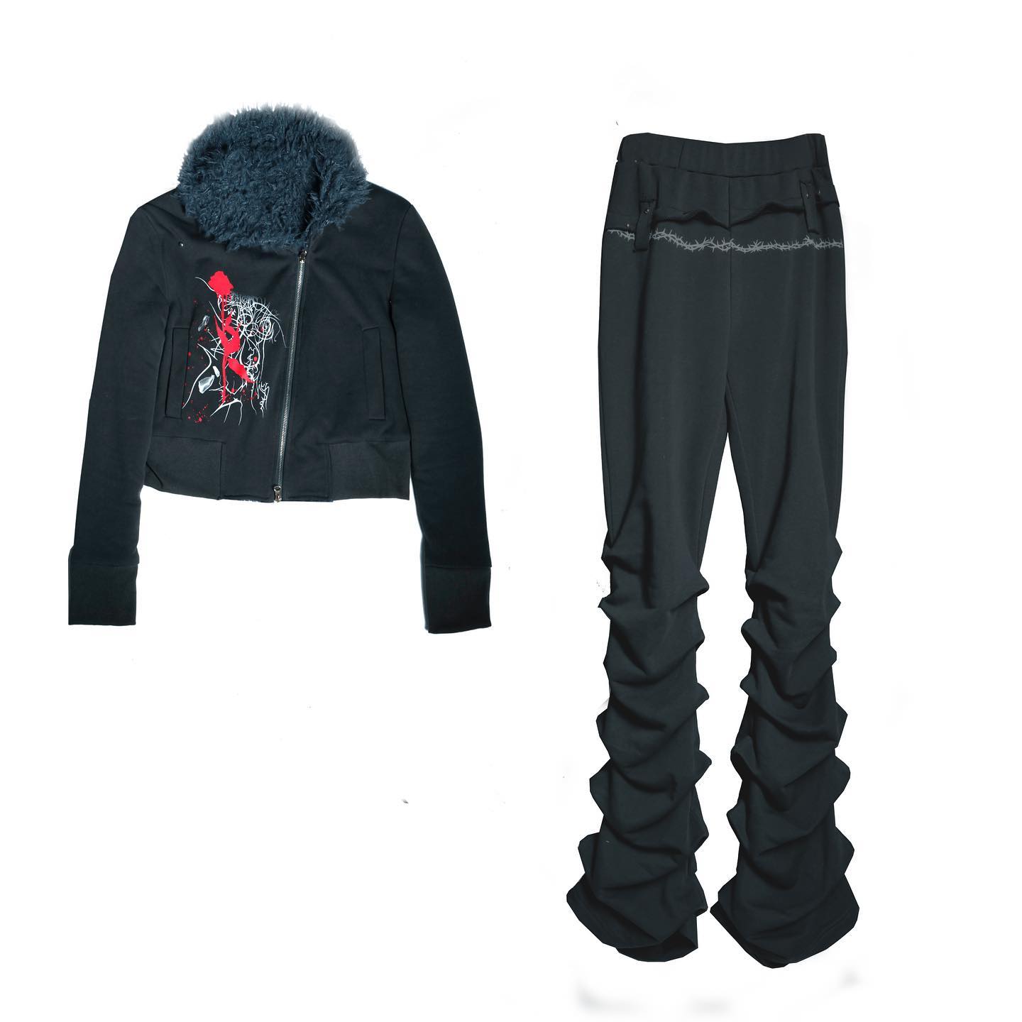 the image shows a women's darkcolored tracksuit. the jacket is cropped and features a faux fur collar and a graphic print.  the pants are black and have a stacked, gathered look. the overall style is edgy and could be categorized as goth, alternative, or streetwear fashion. the pieces are presented on a white background.