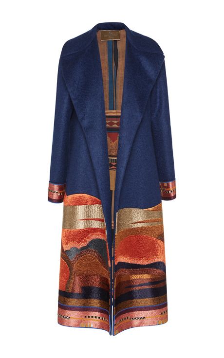a long blue coat with patterned trim.