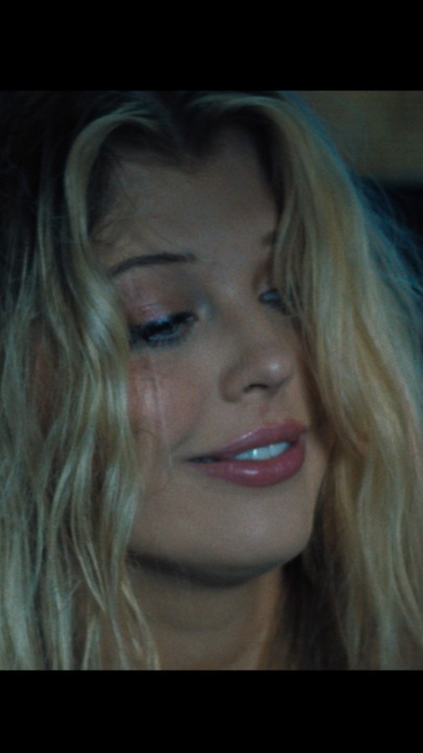 a closeup of a blonde woman's face with a tear running down her cheek. she is wearing makeup. she appears to be upset or sad.