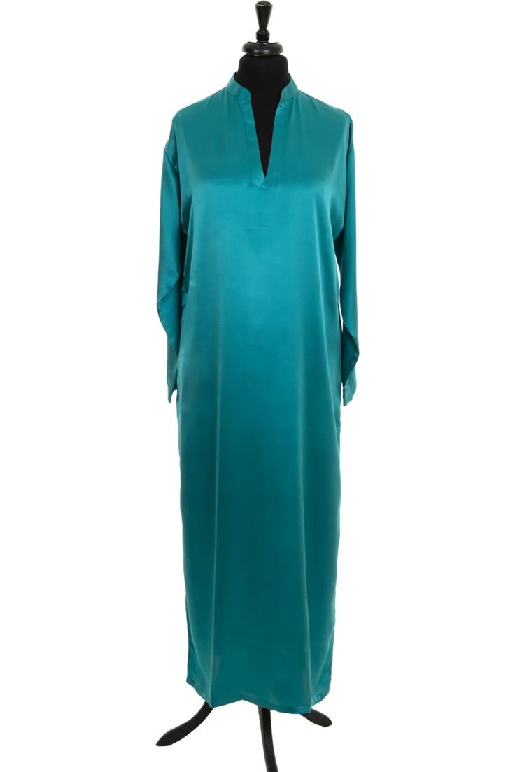 a teal satin dress on a mannequin with a white background. the dress has a vneck and long sleeves. it is a simple and elegant design.