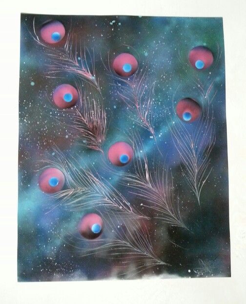 the image is a spray paint painting featuring peacock feathers against a galaxy background. the feathers are depicted with their distinctive eyelike patterns in pink and blue hues. the background showcases a cosmic scene with stars and nebulous patterns in shades of blue and purple. the painting has a dreamy, ethereal quality, evoking a sense of fantasy and space.