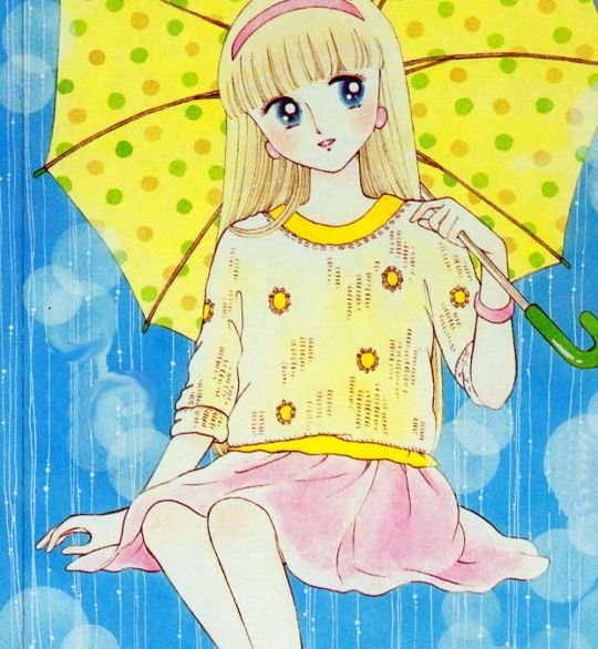 an animestyle drawing of a young girl with blonde hair, blue eyes, and a pink headband holding a yellow umbrella with polka dots. she is wearing a yellow sweater with flower designs and a pink skirt. the background suggests rain.