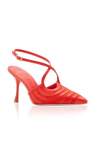 a pair of red high heels with a stiletto heel, pointed toe, straps and leather finish.
