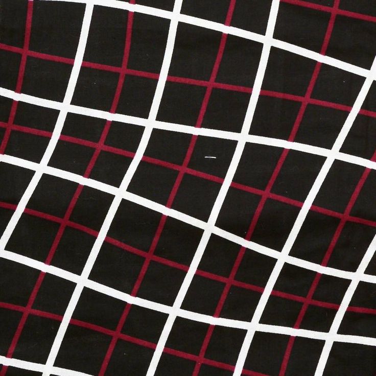 a closeup image of a fabric with a grid pattern. the pattern consists of intersecting white and red lines against a black background. the grid appears slightly distorted due to the fabric's texture.