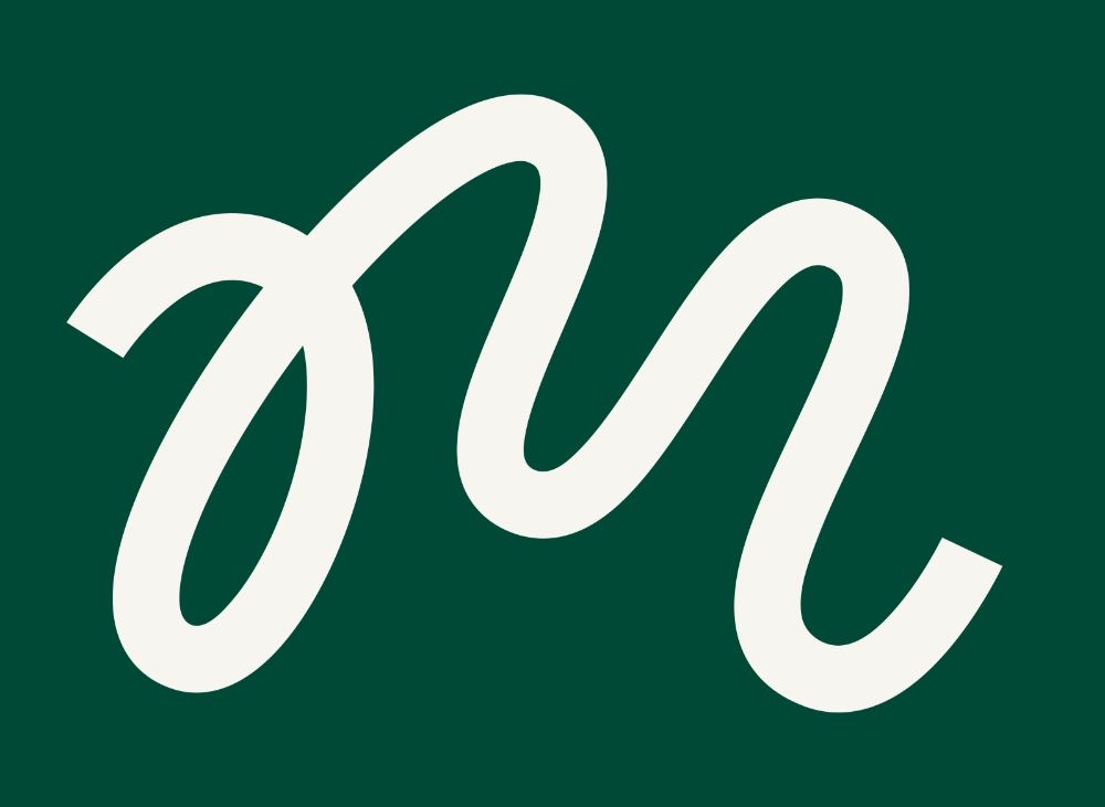 a white stylized lowercase cursive "m" on a green background.
