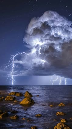 a stunning view of a stormy seascape. the sky is filled with dark clouds, and lightning strikes are illuminating the scene. the waves are crashing against the rocks, and the wind is whipping through the air. the image is a powerful reminder of the raw beauty and power of nature.