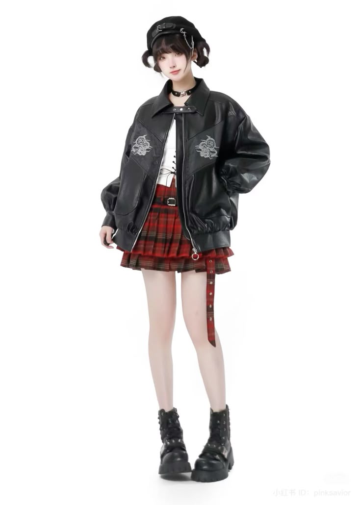 a full shot of a slender woman, likely a model, standing against a stark white background while showcasing an edgy, fashionable outfit. she dons a black beret atop her dark hair, and a black choker adorns her neck. she is wearing a bold black leather jacket with lightcolored embroidered designs on the upper chest, a white top peeking underneath, and a short, twotiered plaid skirt in shades of red and green. a matching plaid belt hangs loosely from the skirt. completing the ensemble are a pair of chunky black platform boots. she is standing in a casual pose, looking directly at the camera.
