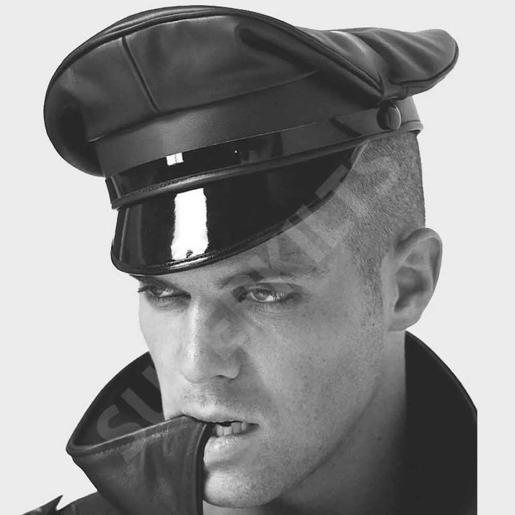 a black and white portrait of a man wearing a black leather cap. he is looking directly at the camera with a serious expression on his face. the man is wearing a black leather jacket. he is a model and is posed in a cool and edgy way. the image is welllit and the focus is sharp.