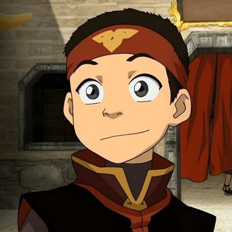 a young boy wearing a fire nation headband and clothing with a smirk on his face.