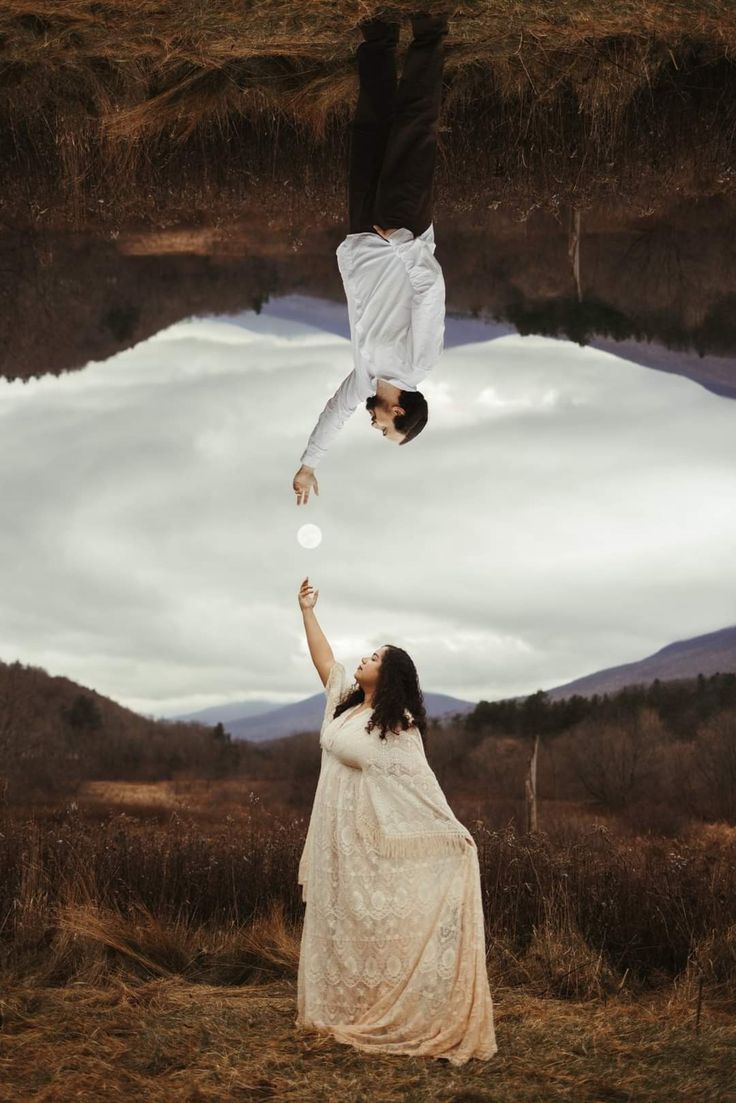 a man hangs upside down in the sky, reaching toward the moon. a woman stands in a field, reaching up toward the moon. the man and woman are separated by the sky and clouds, but they are connected by their love and hope. the image is surreal and dreamlike, evoking a sense of wonder and possibility.