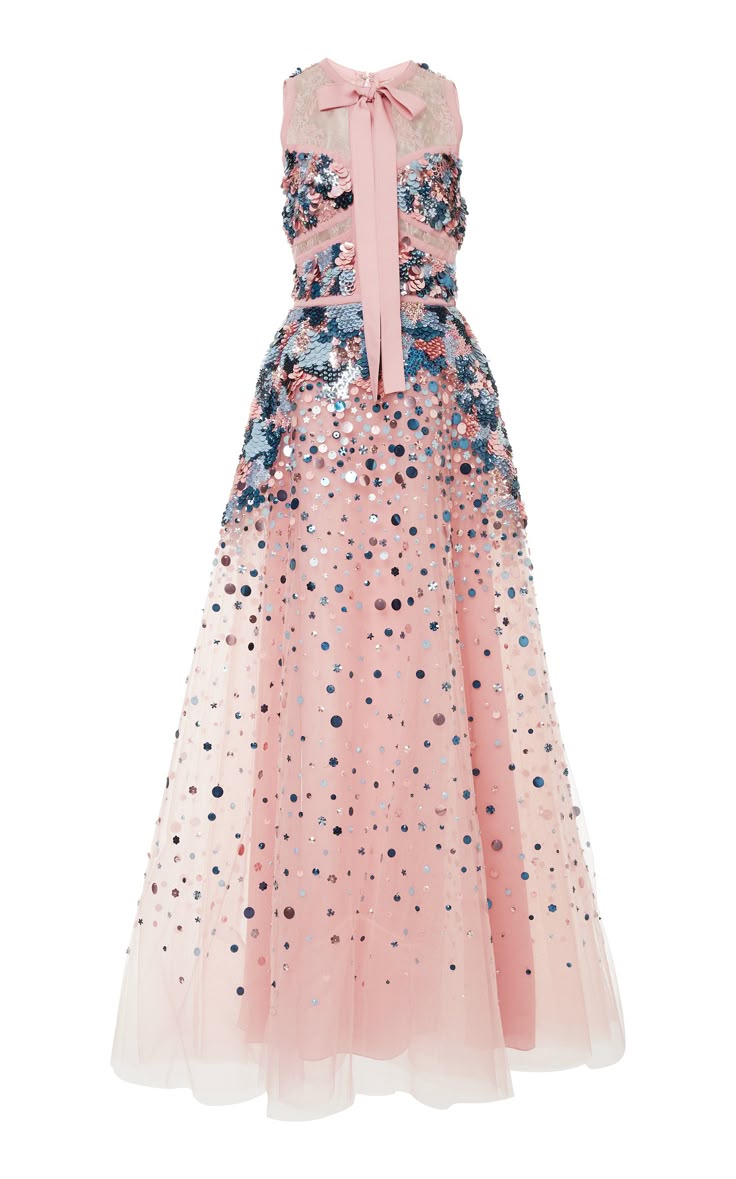 a pink floorlength gown is showcased on a white background. the sleeveless bodice is adorned with sequins in shades of blue, pink, and silver. a pink ribbon is tied into a bow at the neckline, cascading down the front of the dress. the full skirt is made of layered tulle, embellished with scattered sequins.