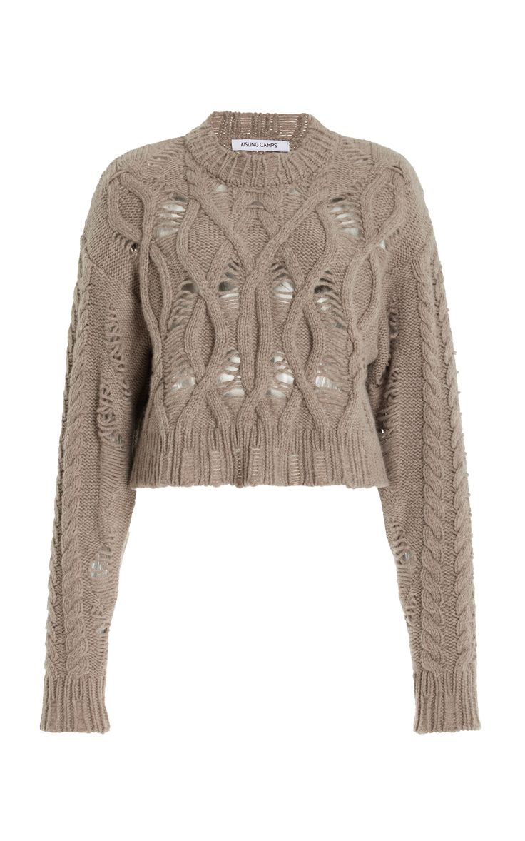 a brown cable knit cropped sweater with long sleeves. the sweater has a relaxed fit and is made of a soft, comfortable knit fabric. the sweater is perfect for casual wear and can be styled with jeans, skirts, or pants.