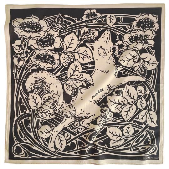 the image shows a beige square bandana or scarf with a black and beige design. the design is reminiscent of art nouveau style, featuring an intricately detailed fox leaping through a stylized floral arrangement. the flowers appear to be roses or similar blossoms with bold, dark centers. the black lines create a flowing, organic pattern around the fox, creating a sense of movement and depth. the overall style is elegant, decorative, and somewhat whimsical. the fabric looks smooth and possibly silky.  the bandana's edges are clearly visible, suggesting a soft, slightly folded drape.