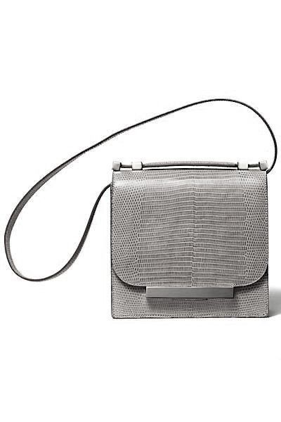 a grey shoulder bag with a reptile skin pattern is displayed on a white background. the bag has a small, rectangular shape with a foldover flap, and a metal clasp. the shoulder strap is thin and grey. the bag appears to be made of leather or a similar material.