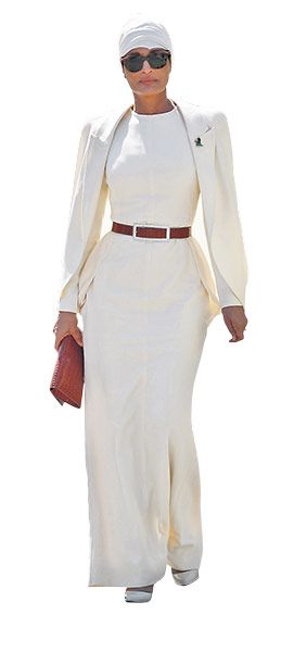 a fulllength shot of a woman wearing a stylish, allwhite pantsuit.  the outfit includes a long, flowing pantsuit with a matching top and a brown belt.  the woman is accessorized with sunglasses and a white headwrap. she is standing against a plain white background.  the overall impression is one of elegance and sophistication.