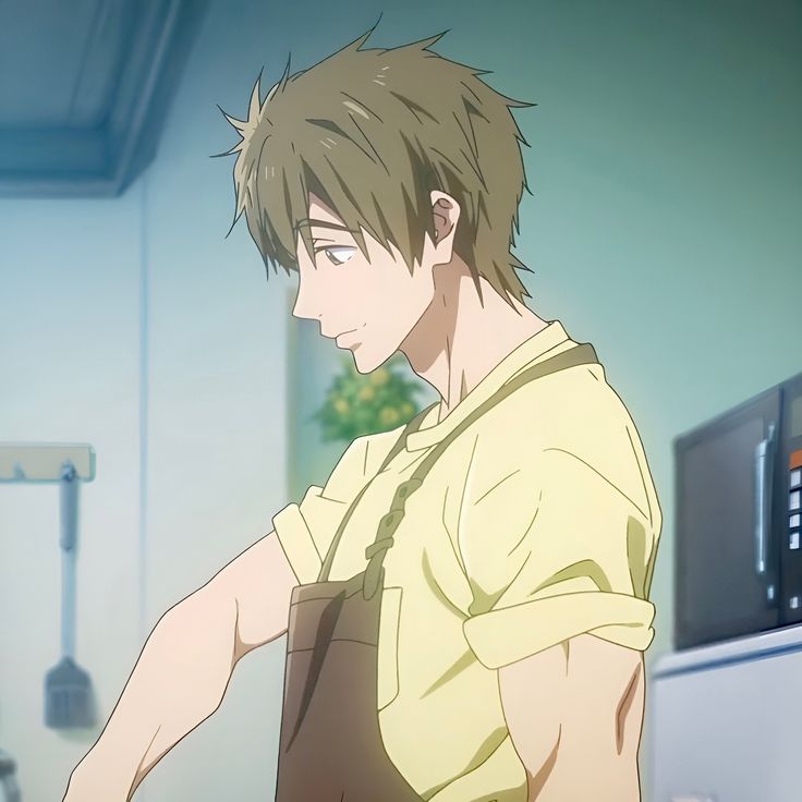an anime boy with brown hair is smiling and wearing a yellow shirt and brown apron. he looks happy and friendly, and he is likely cooking in a kitchen. the image is drawn in a manga style.