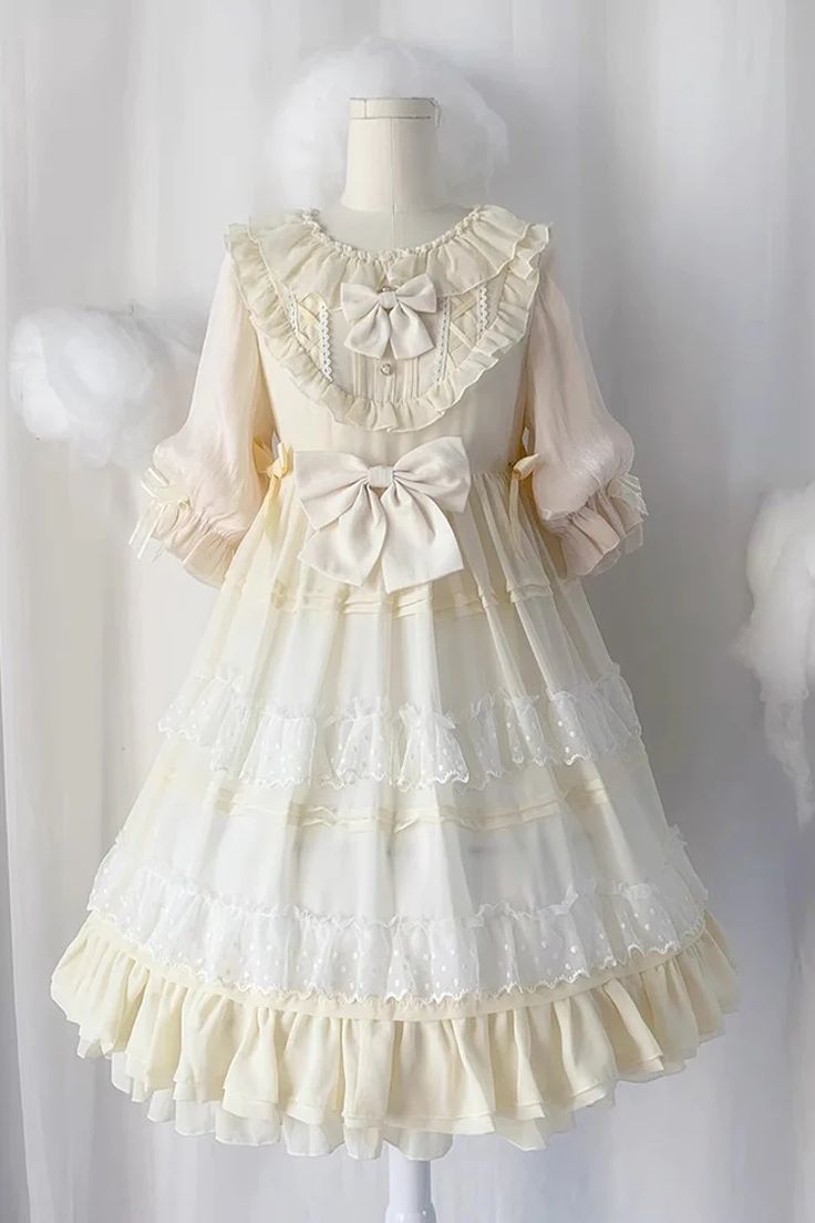 a delicate, creamcolored lolita dress displayed on a mannequin against a white backdrop. the dress features intricate lace details, multiple layers of ruffles, and delicate bows on the bodice and waist. the lighting is soft and emphasizes the lightness and femininity of the garment.