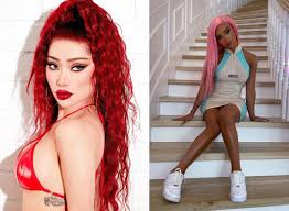 the image is a diptych showing two women with contrasting styles. on the left, a woman with vibrant red, curly hair wears a red bikini top, showcasing a more sultry and vibrant look.  her makeup is bold and striking.  on the right, a woman with long, light pink hair sits on a staircase, wearing a lightcolored, short dress and white sneakers.  her style is more delicate and dolllike,  emphasizing a pristine and polished aesthetic.  the contrast in hair color, clothing styles, and overall vibe creates a visually interesting comparison between the two women.