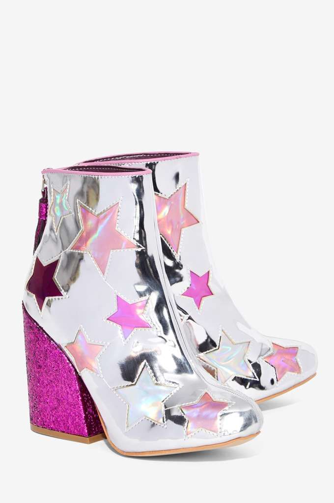 a pair of silver ankle boots with pink glitter heels and star embellishments.