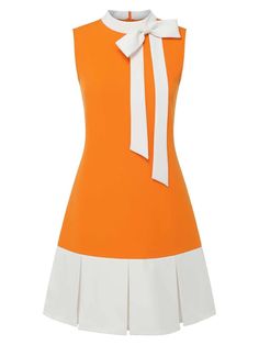 a sleeveless orange dress with a white bow at the collar and a pleated white skirt. the dress is a retro style.