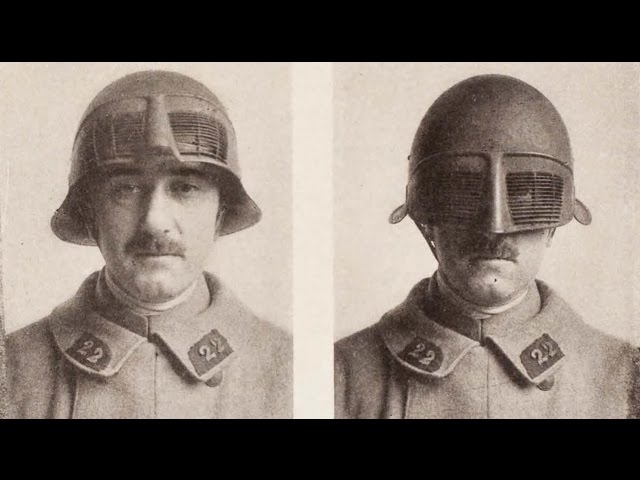 this is a black and white photo of two soldiers wearing helmets that have a screen over the eyes. the soldiers have moustaches and are both wearing uniforms with buttons on the collar. the helmets are made to protect the soldiers' heads. the image likely comes from the early 20th century.