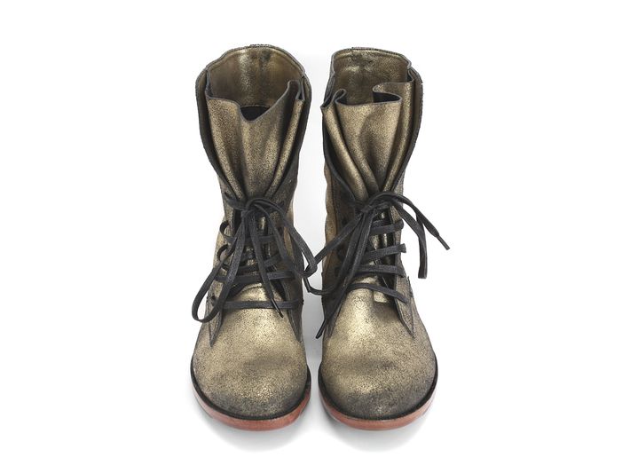 a pair of metallic gold laceup boots are presented on a white background. the boots are positioned side by side, facing forward with their laces untied. the tops of the boots are folded down, giving them a relaxed, slouchy appearance. the soles have a thin, reddishbrown edge.