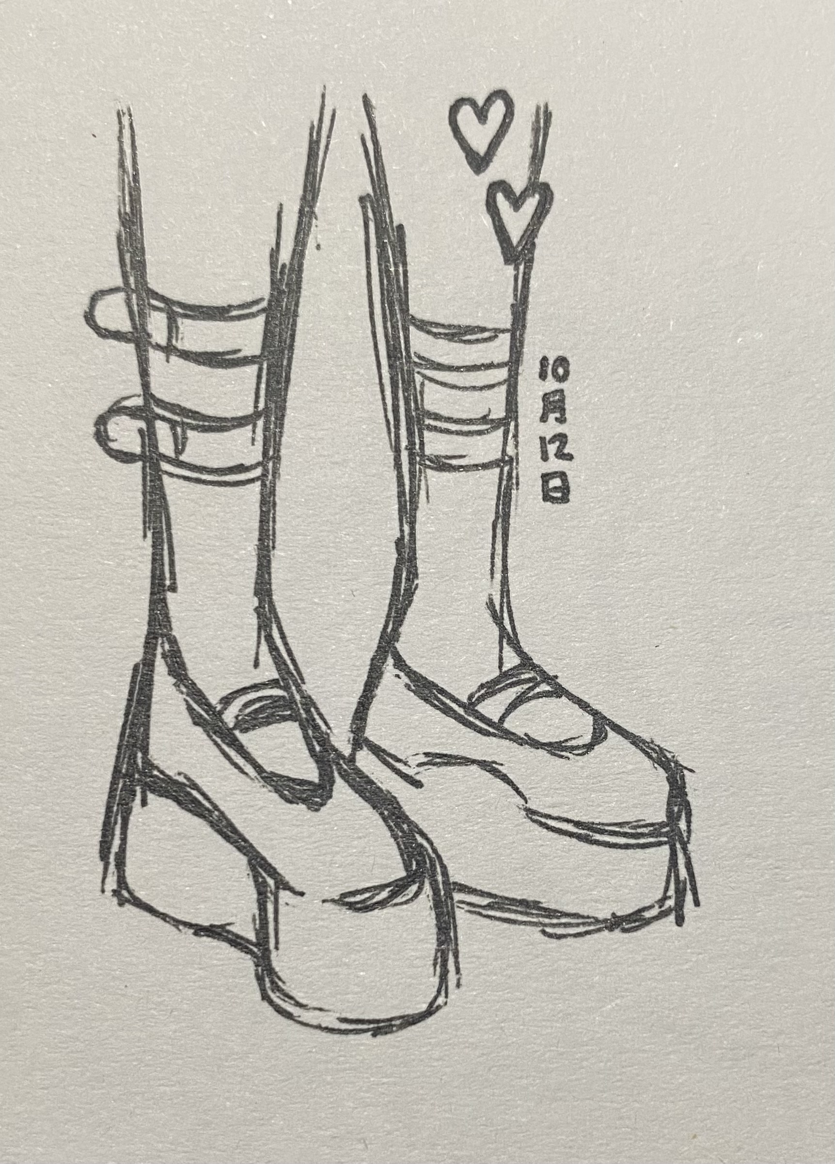 a handdrawn sketch of a pair of platform boots with multiple straps. the drawing style is loose and sketchy, with visible lines and shading. two small hearts are drawn near the top of the boots. the background is a light beige color. the boots appear to be highheeled platform shoes with thick straps. the overall style is reminiscent of grunge or alternative fashion.