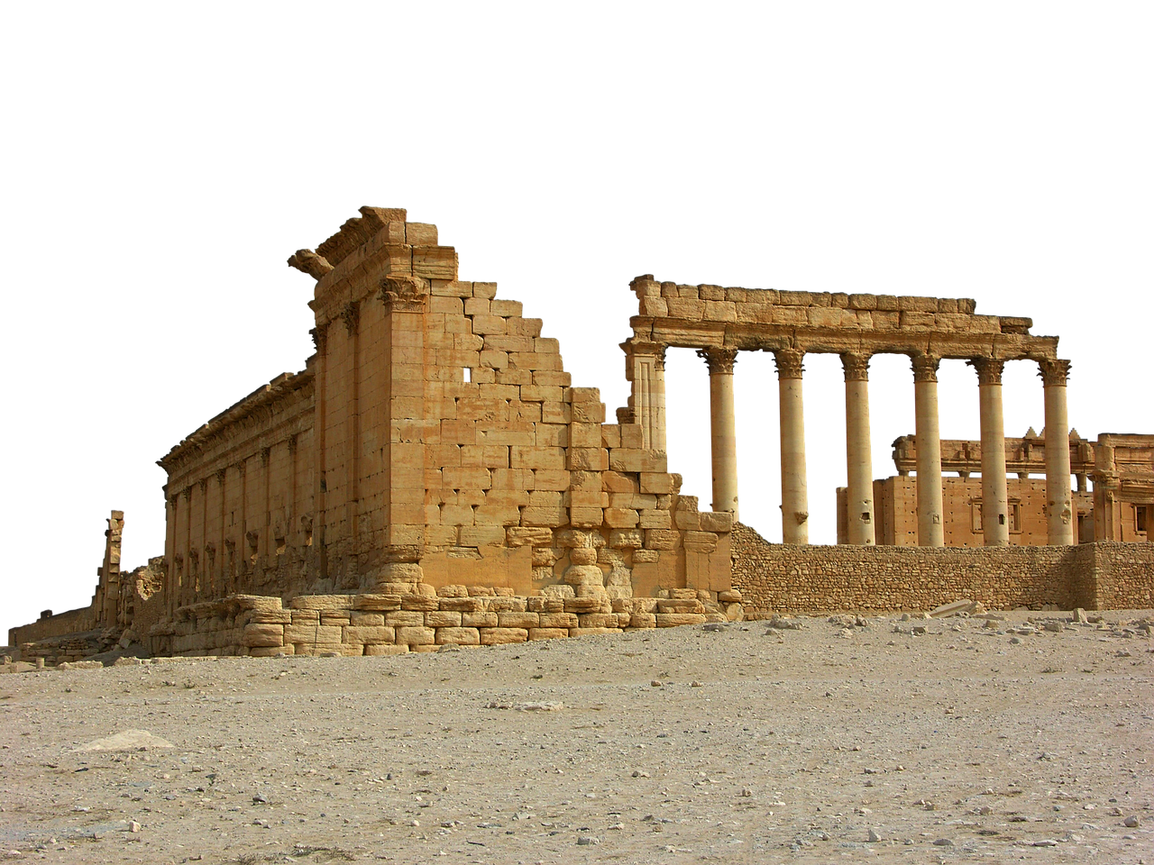 the image shows the ruins of palmyra, an ancient city with columns and buildings standing amidst a desert landscape. the structures are made of stone and appear weathered, with some portions crumbled or missing, indicating their historical significance. the foreground is sandy ground with small rocks, while the background is black.