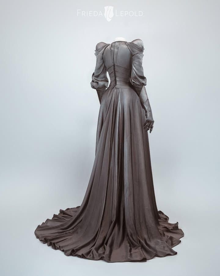 a long, elegant grey gown is displayed from the back. the dress has a fitted bodice with long, puffy sleeves and a floorlength skirt with a train. the dress is made of satin fabric and has a vintage style. it is displayed on a mannequin in a studio setting.