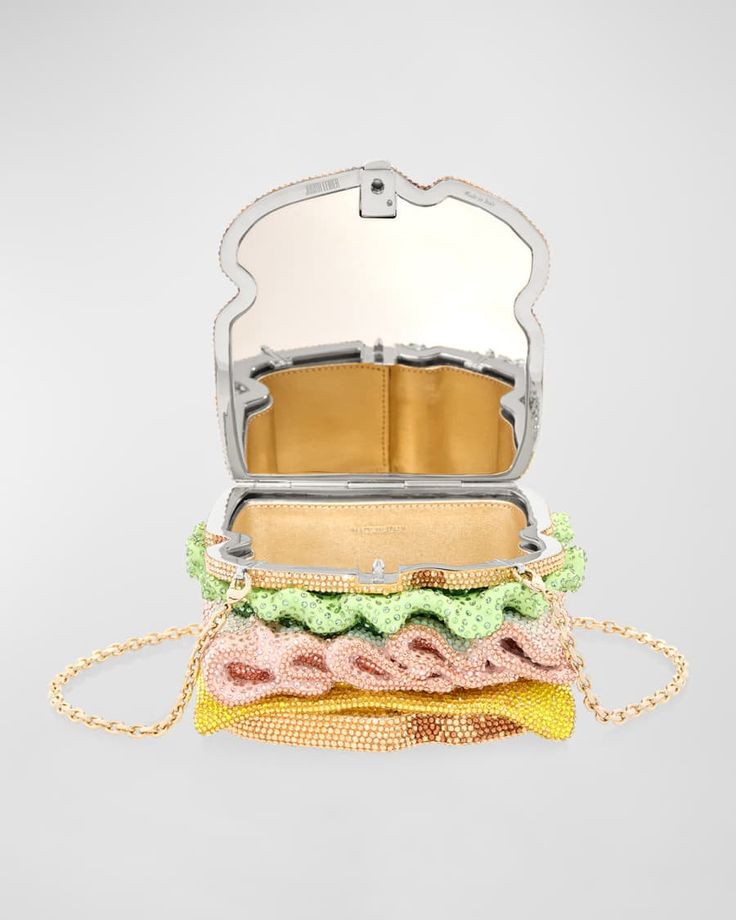 a sparkling crystal sandwich purse, a luxury fashion accessory that's both whimsical and glamorous. it's adorned with crystals in shades of green, pink, and yellow, creating a playful and eyecatching design. the purse has a metallic gold chain strap for versatile styling, and its mirrored interior adds an element of sophistication.