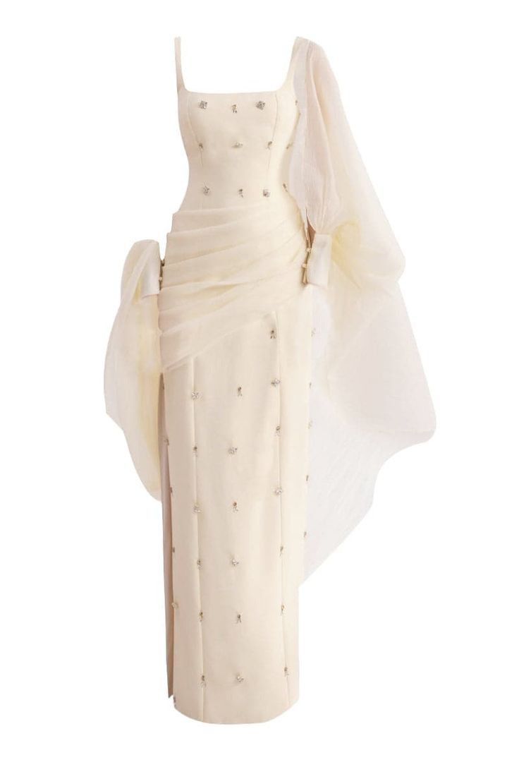 a white formal gown with a sheer tulle overlay. the dress features a fitted bodice with beaded details and a flowing skirt. the tulle overlay adds a touch of romance and whimsy to the look. this dress would be perfect for a wedding, prom, or other special occasion.