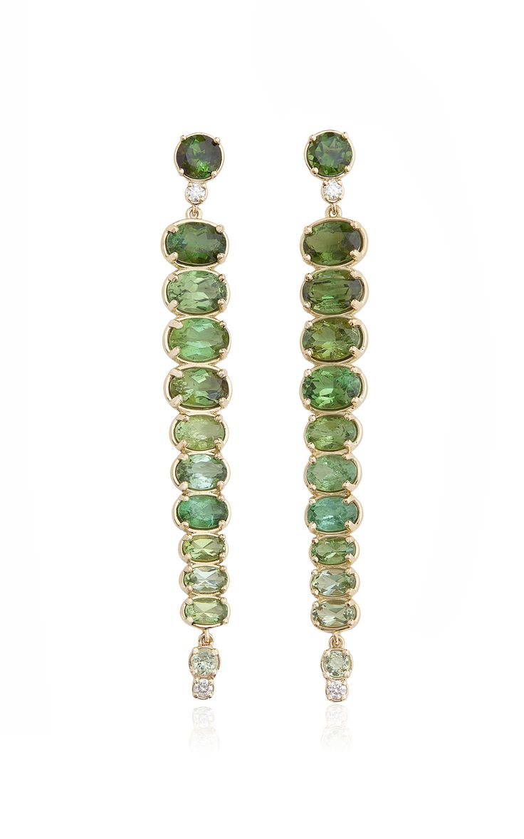 a pair of long, gold earrings featuring a cascade of green gemstones, each a slightly different shade, arranged in a gradient from dark green to light green. the gemstones are ovalshaped and are set in a bezel setting, with a small diamond at the bottom of each earring. the earrings are suspended from a delicate gold chain and dangle gracefully from the earlobe. the image captures the beauty and sophistication of the jewelry, highlighting the rich color and intricate design of the earrings.