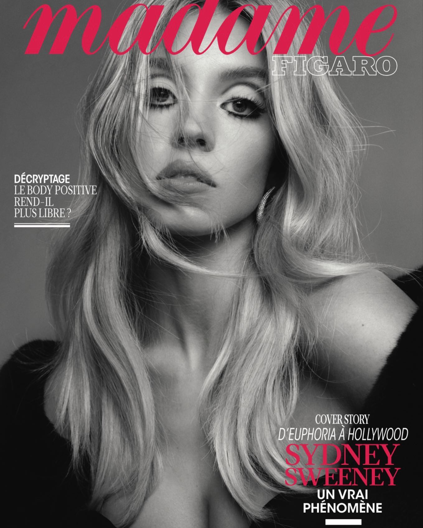 the image is a black and white cover of madame figaro magazine featuring actress sydney sweeney.  the cover is predominantly a closeup portrait of sweeney with her hair cascading around her shoulders. text on the cover indicates a cover story about sweeney and mentions "body positive" and "euphoria," referencing her role in the hbo series.  the overall style is elegant and sophisticated.