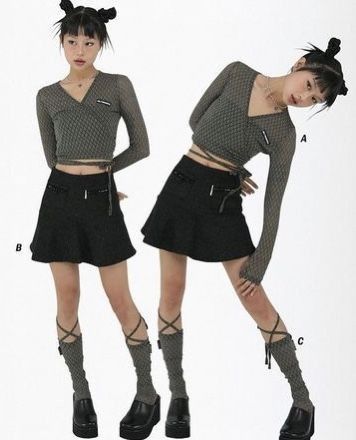 the image shows two models wearing similar outfits.  the outfits are in a dark, grungy style reminiscent of y2k or 90s fashion.  both models wear a gray wrapstyle longsleeved top, a black miniskirt, and dark gray kneehigh socks with crisscross straps at the calves. they are also wearing chunky platform shoes.  one model is standing straight, while the other is posed in a more dynamic stance, leaning forward.  both have their hair styled up in buns. the background is plain white, allowing the outfits to be the focal point.