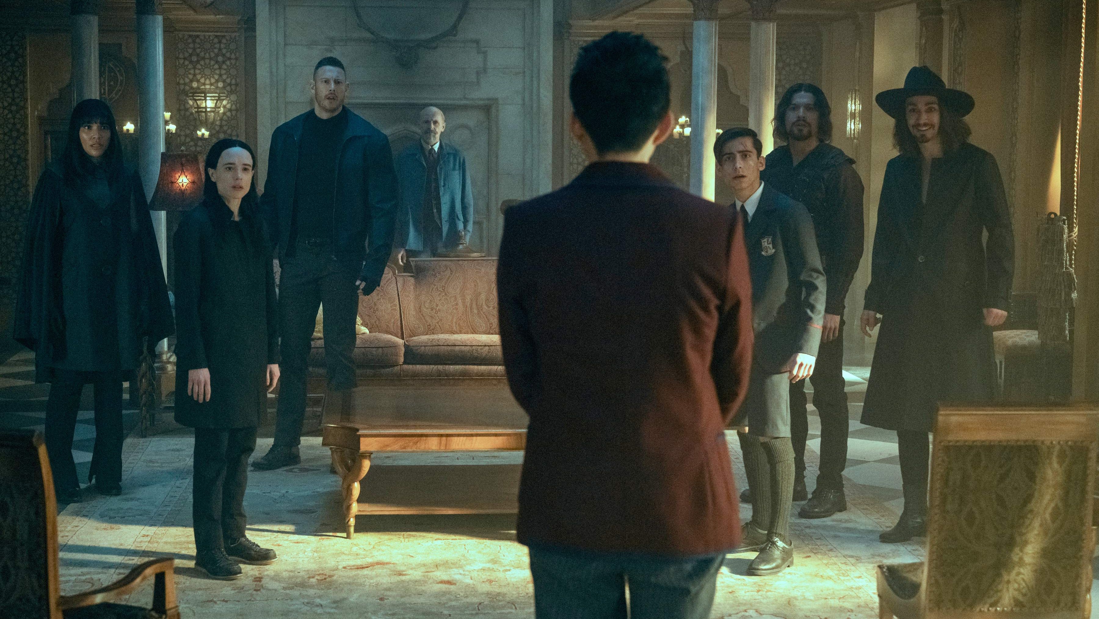 a tense scene unfolds in a dimly lit, opulent room within a grand mansion. a young man, his back turned to the viewer, stands facing a group of seven individuals.  the group's expressions range from stern to apprehensive, creating an atmosphere of confrontation.  the room's décor suggests wealth and history, with dark wood and rich fabrics. the overall mood is one of suspense and drama, hinting at a clash of wills and potentially supernatural elements.