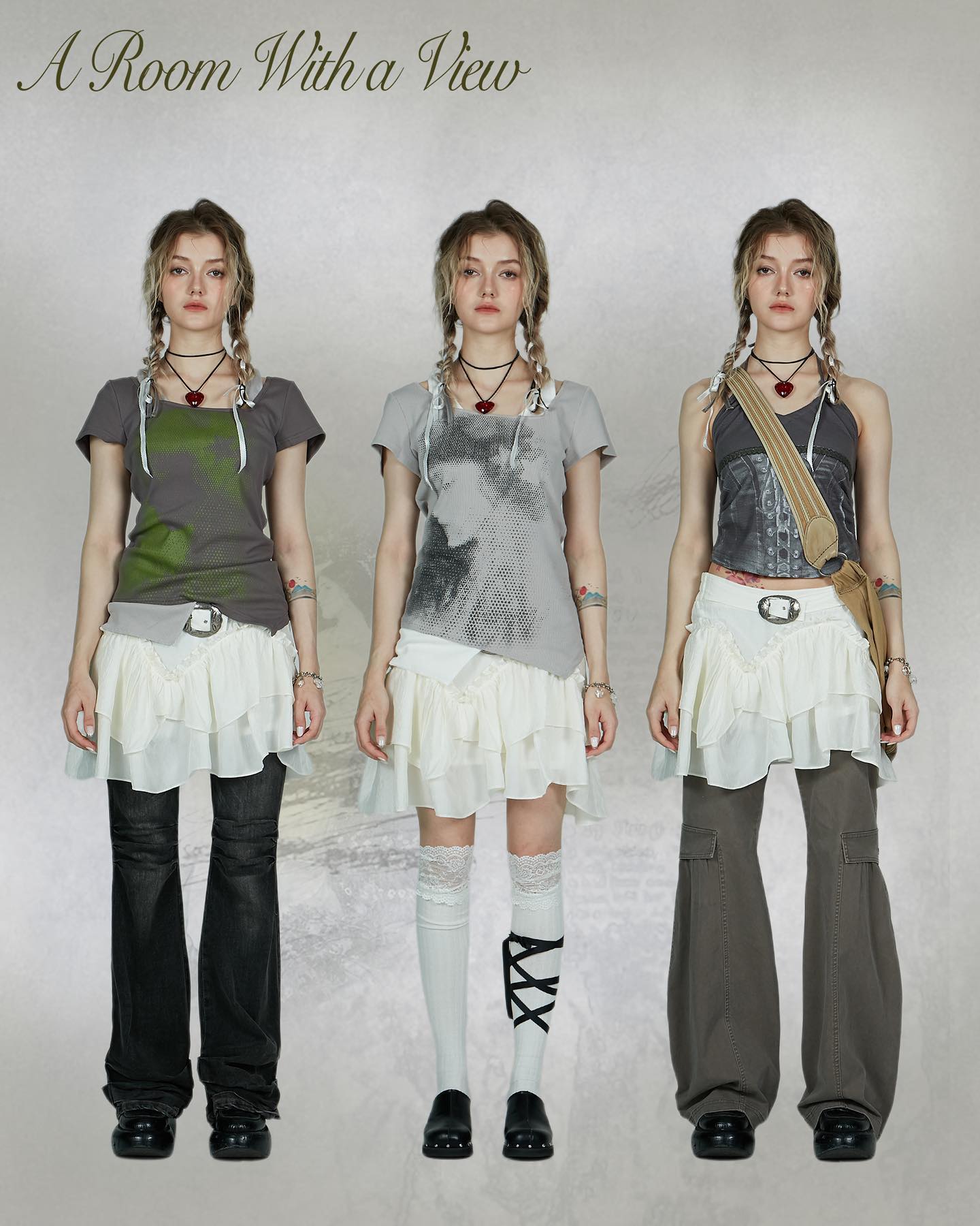 three young women are standing in a studio shot, showcasing different outfits. each is wearing a variation on a layered ruffle skirt and top, with accessories including a bag, necklace and socks. their hairstyles are similar braids, and their poses are consistent. the title "a room with a view" is displayed at the top of the image.  the overall style evokes a vintage or retro feel with a modern, alternative twist. the clothing is mostly in shades of grey and white.