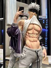 loseup view of a collectible figure, possibly from anime or manga, depicting a muscular male character. the figure is shirtless, showcasing a welldefined sixpack, and is wearing grey sweatpants and a purple jacket.  he's holding a phone up as if taking a selfie, and has a blindfold across his eyes. the figure is highly detailed and appears to be made of highquality material. the background is blurred but shows a computer screen and other items suggesting a setting possibly related to a convention or display.