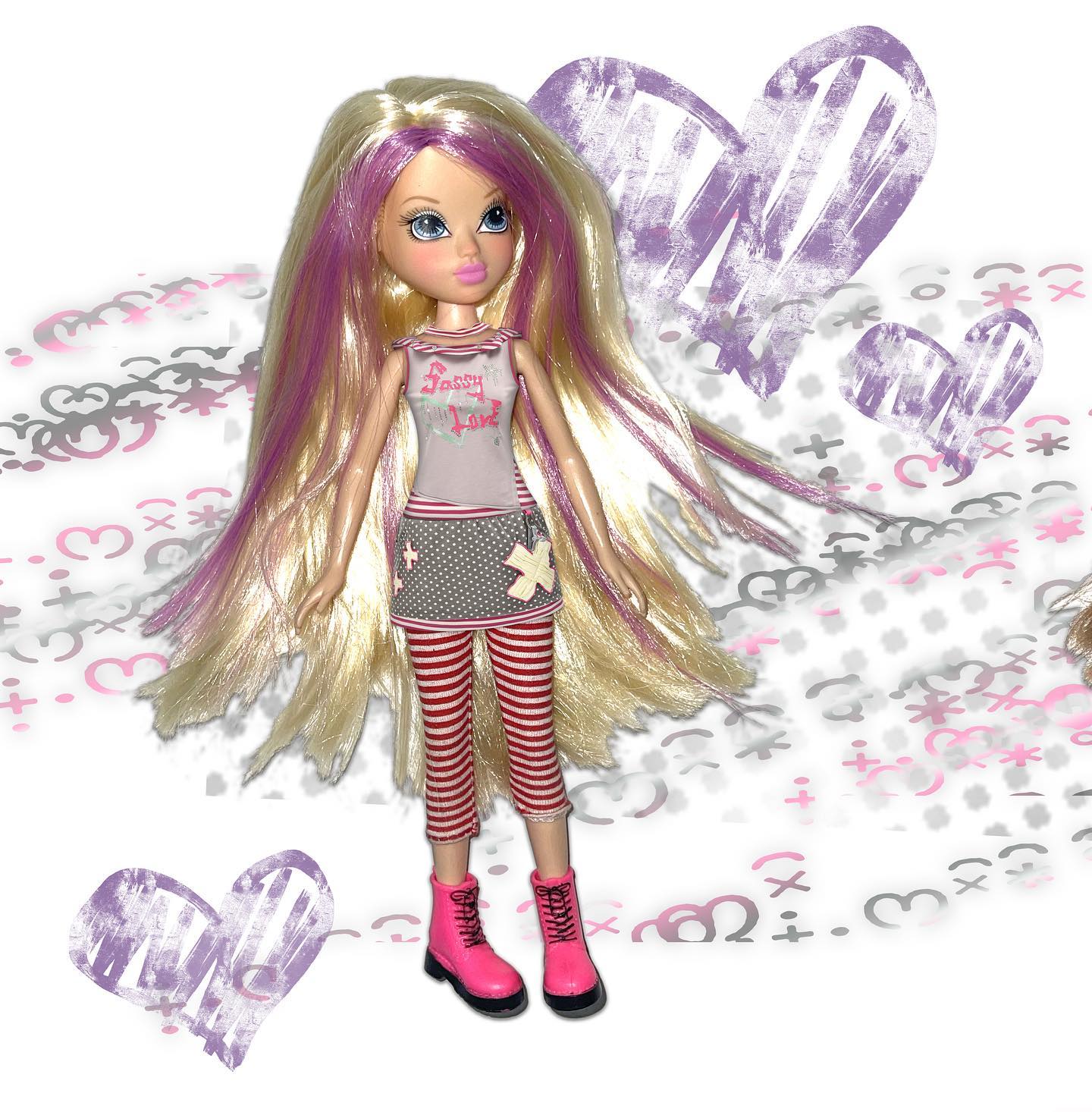 a bratz sasha doll stands against a whimsical background of hearts and doodles. she has long blonde hair with streaks of pink, and is wearing a gray and pink shirt that says "sassy love," red and white striped leggings, and pink boots. the doll is positioned in the center of the image.