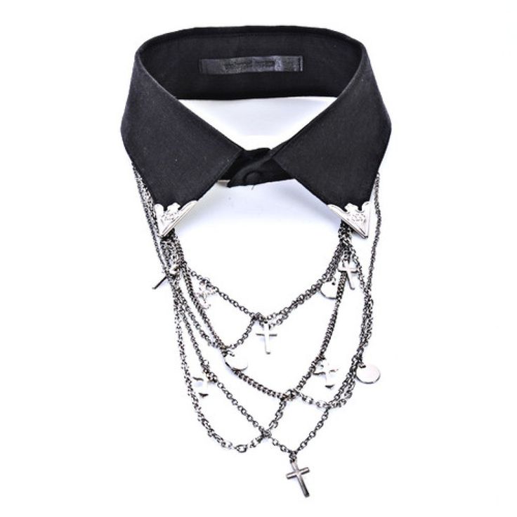a black collar with silver chains and cross pendants hanging from it. the chains also have small, circular silver discs attached to them. the collar has silver triangular embellishments at the collar points.