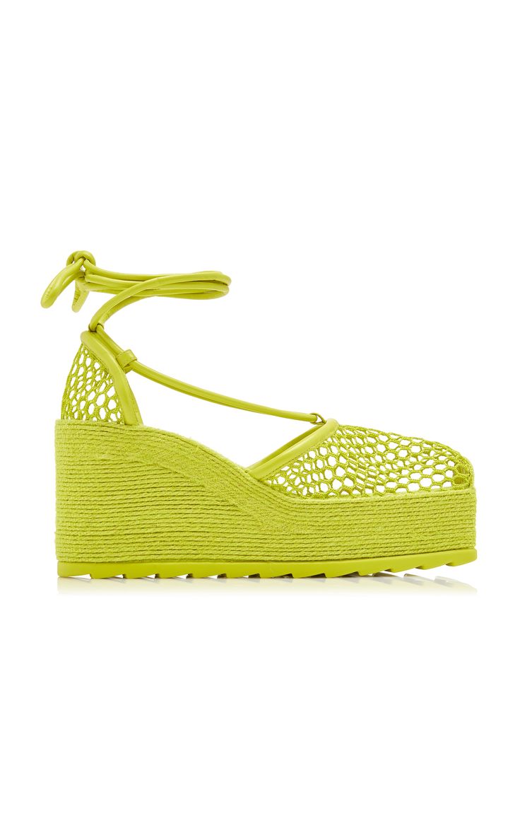pair of lime green women's wedge sandals are shown on a white background. the sandals are made of a woven material and have a platform sole. they feature laceup ankle ties. the shoes are presented in profile view and angled slightly.